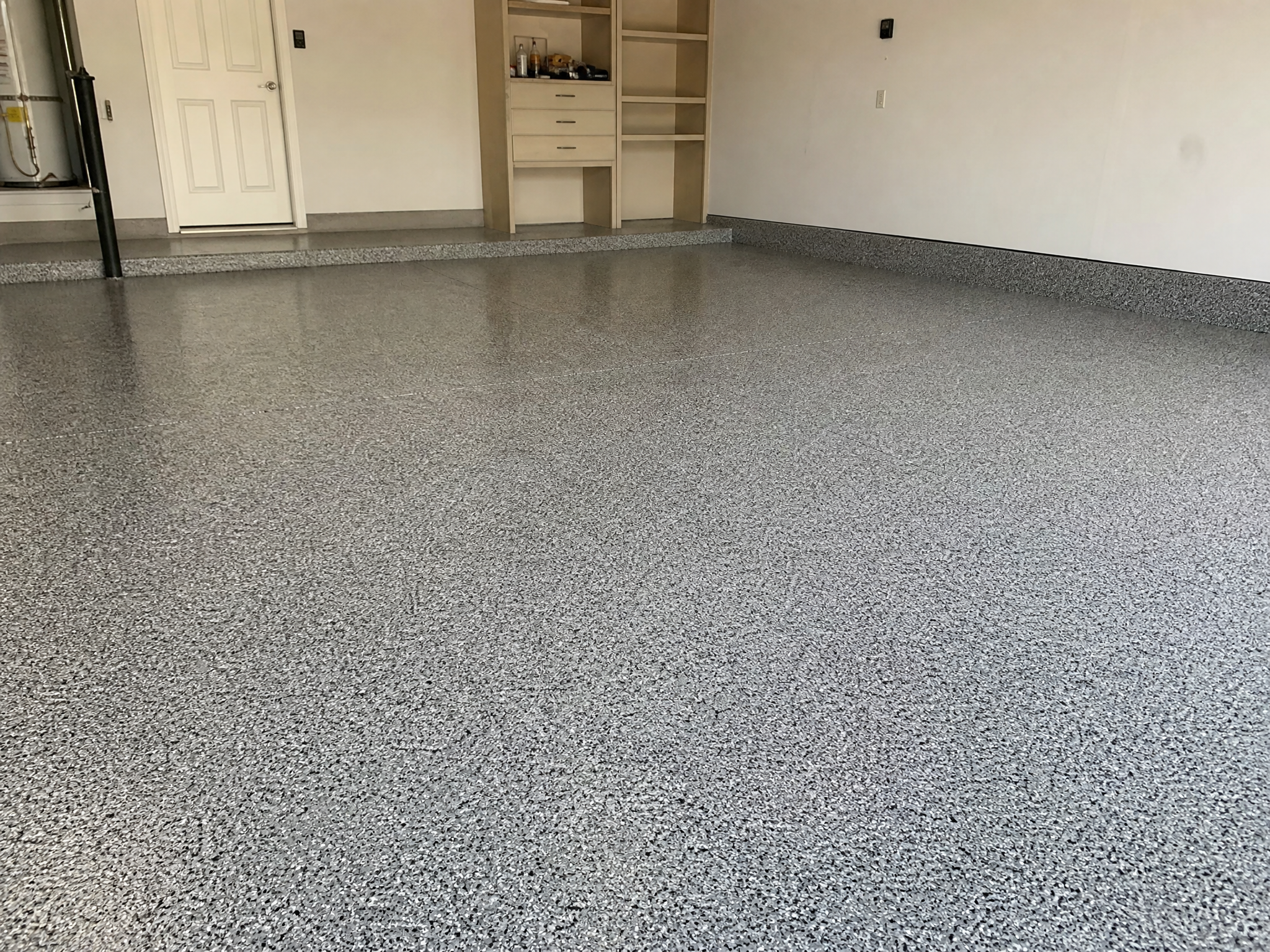 Completed epoxy garage floor coating showing professional quality workmanship in a American home
